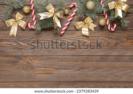Composition with beautiful Christmas decorations and fir branches on wooden background