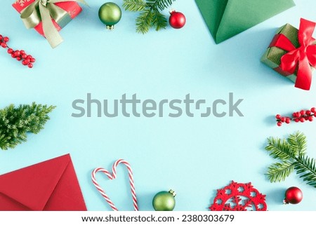 Christmas or winter composition. Xmas decorations, envelopes on pastel blue background. Christmas, New Year, winter concept. Flat lay, top view, copy space