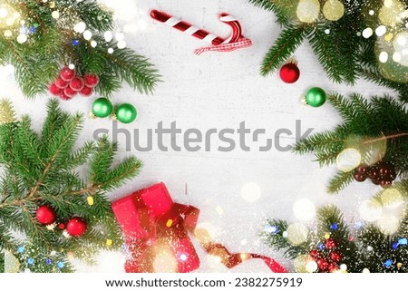 Christmas gift giving flat lay frame - christmas present in red box on white wooden table background with copy space with bokeh