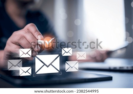 Businessmen use laptops with communication icons, letter icons, email icons, and newsletter email and protect your personal information or spam mail, Customer service call center contact.
