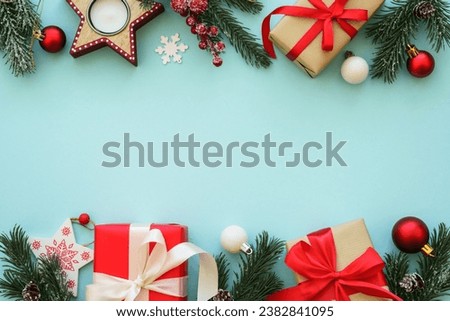 Christmas presents and decorations with fir tree at blue background.