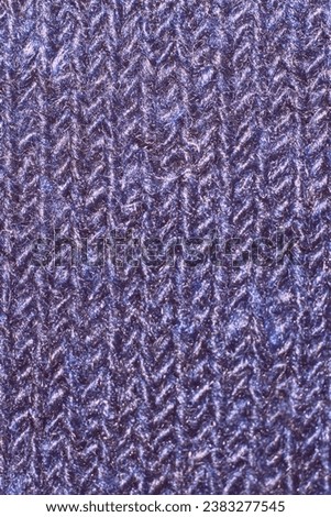 Texture of blue knitted fabric close up, background