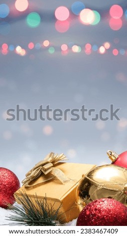 Gift box and Christmas ornament with blurred lights background. Celebration background