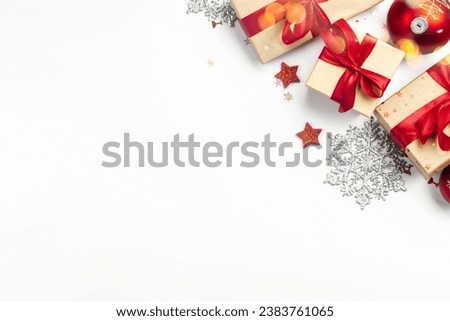 Bright Christmas background with christmas decorations, balls, gift boxes with red ribbon, tie bow on white background with copy space top view. Winter holidays, New Year concept