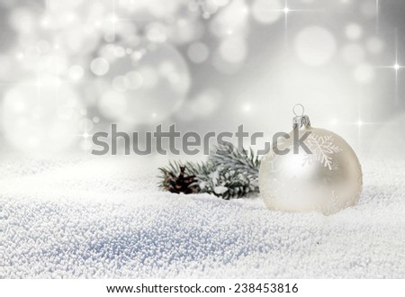 Christmas balls and fir branch in snow on bokeh background 