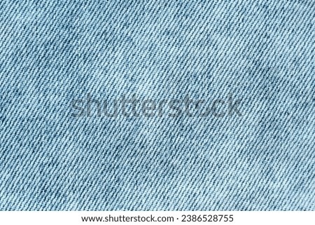 Texture background: light blue white denim cotton fabric, jean clothing, clothes textile. Jeans tissue, backdrop sewing material