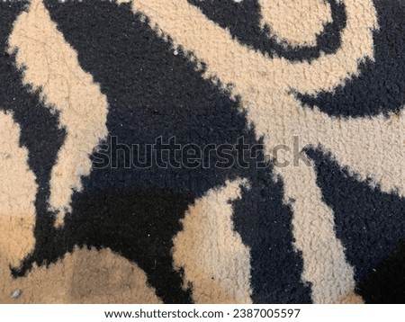 a light brown base carpet with batik carved ornaments