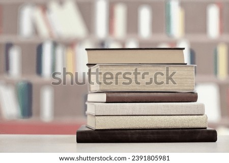 wooden book in the library on blurred background, closeup. space for text