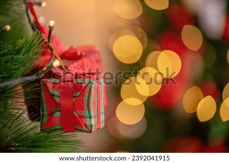 Christmas Tree with Decorations and Gift box present on colorful pine tree with laugh smile happy parent family celebrate party in Christmas day at home. colorful balls on pine tree with bokeh.