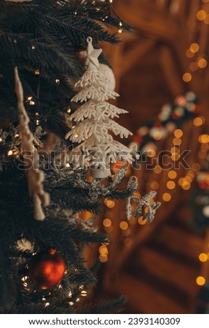 Christmas tree decorations hang on the tree