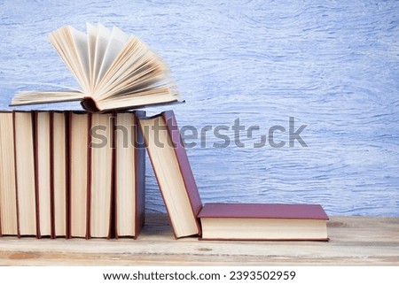 open book, books on the blue background. Back to school. Education. Copy space for text