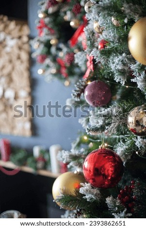 Decorated Christmas, New year room with beautiful snow-covered fir tree and golden ball on lights background 