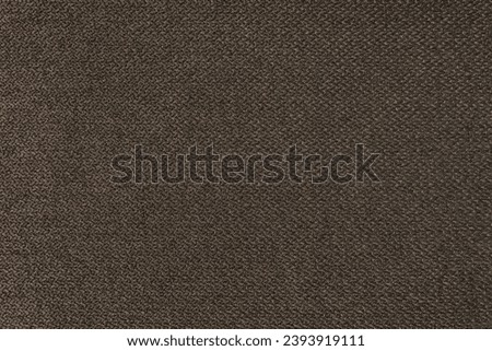 Textile backgtound, brown coarse fabric texture, jacquard woven upholstery, furniture textile material, wallpaper, backdrop. Cloth structure close up.