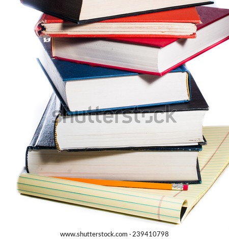 Stacks of books on yellow legal pad on white background.