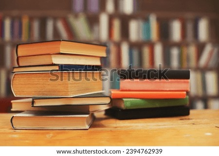 stack of books on wooden table in library. space for text