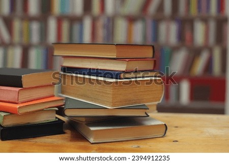 stack of books on wooden table in library. space for text