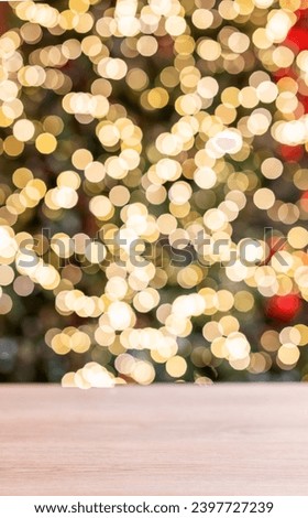 Wooden empty tabletop in front of a Christmas tree with red decorations and lights in blurred. New Year banner concept for product display or montage. Free space for text.