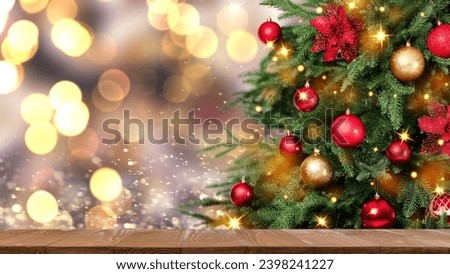 Christmas tree decorated with red and golden balls near wooden table against blurred background. Banner design with space for text