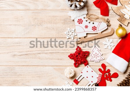 Top view of Christmas decorations and toys on wooden background. Copy space. Empty place for your design. New Year concept.