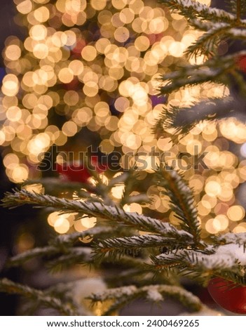 The blurred yellow lights are out of focus. Christmas background.