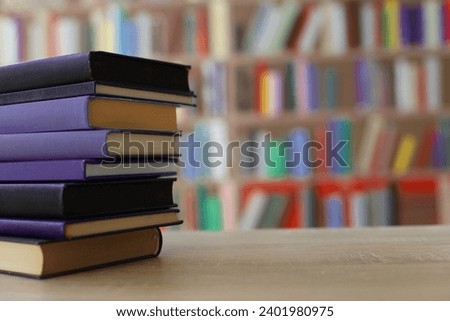 stack of books on table in library education school