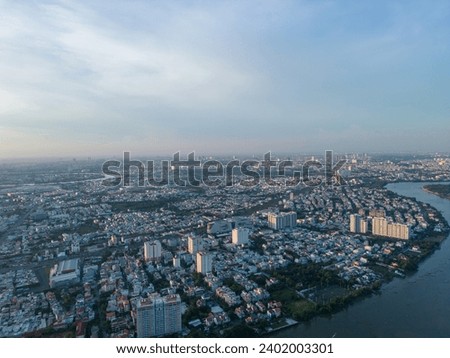 Panoramic view of Saigon, Vietnam from above at Ho Chi Minh City's central business district. Cityscape and many buildings, local houses, bridges, rivers. Travel and landscape concept.