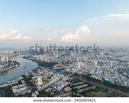 Panoramic view of Saigon, Vietnam from above at Ho Chi Minh City's central business district. Cityscape and many buildings, local houses, bridges, rivers. Travel and landscape concept.