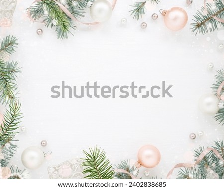A soft and delicate New Year's border with pink and white Christmas ornaments, pine branches, and shimmering lights on a white background.