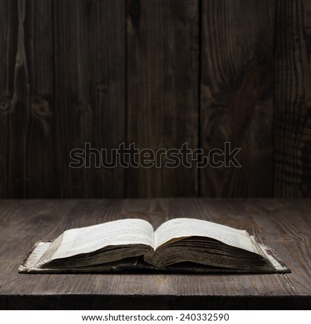 Image of a book? on wooden background in a dark space
