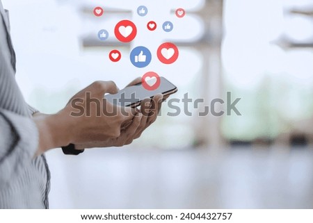 Man holding smartphone with social media icon