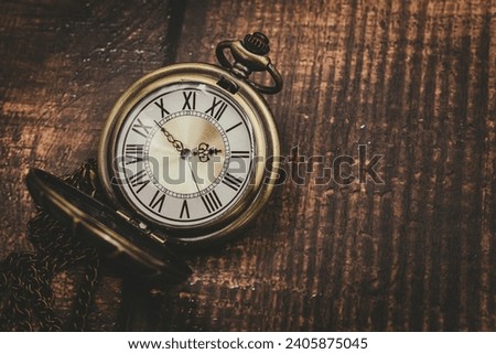 old pocket watch classic clock time vintage retro style on wood background with space for text