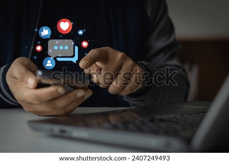 Man using social media marketing content on mobile phone with notification icons of like, message and comment above smartphone screen. Friends network community sharing multimedia communication online