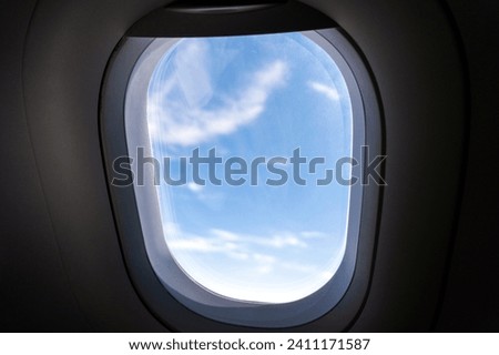 window of airplane. View of the clouds through the porthole.