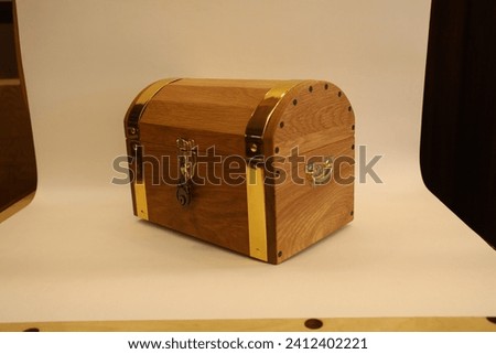 a jewelry box made of oak and gold decorations