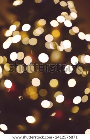 A vertical shot of golden bokeh lights, with a blurred background and a bright, luminous effect