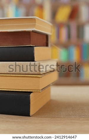 Stack of books on the table in library education