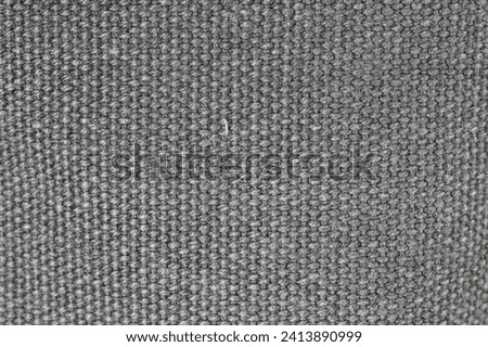 Gray woven or knit fabric texture surface. Top view, macro shot, no people.