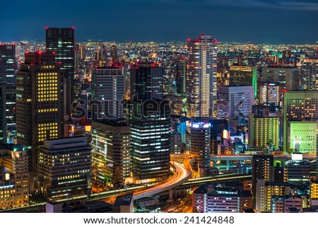 The lights of Osaka turn on as evening settles in over the city.
