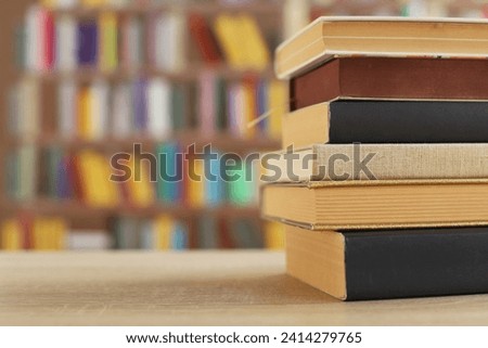 Stack of books on the table in library education