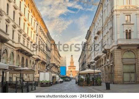Street in Milan with the view of Sforzesco castle, Italy