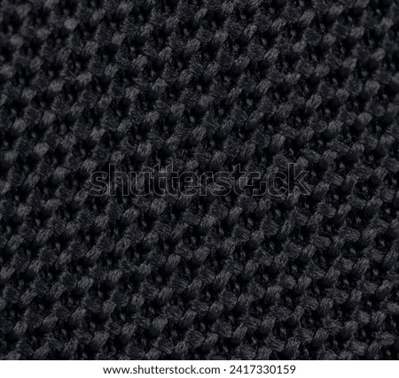 Dark braid knit craft background macro clsoe up view