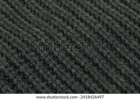 Texture of black woolen sweater closeup image