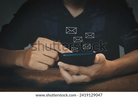 New email notification. Communication. Businessman holds smartphone with email notification in icon.
