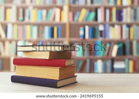 STACK OF BOOKS ON THE TABLE IN LIBRARY