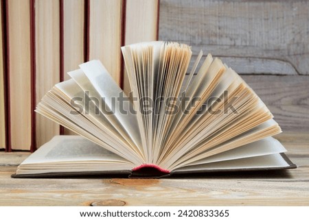 Open book, hardback books on wooden table. wooden background. Back to school. Education. Copy space for text