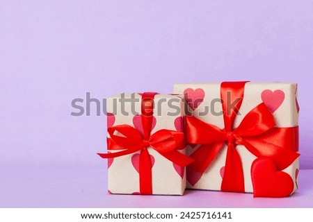 gift box with red bow and red heart on colored background. Perspective view. Flat lay.