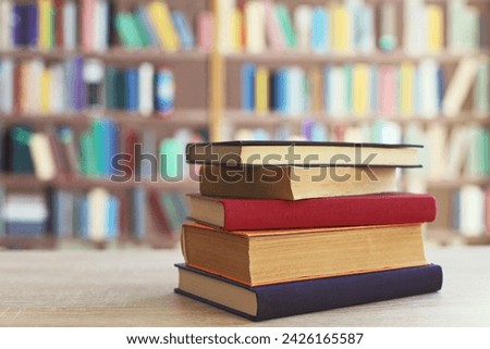 STACK OF BOOKS ON THE TABLE IN LIBRARY