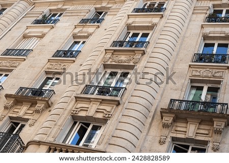 Elegant facade of a stone building in a Parisian avenue