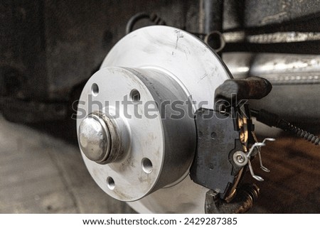 brake disc in the rear wheel of a car, car workshop, car repair, car mechanic, damaged