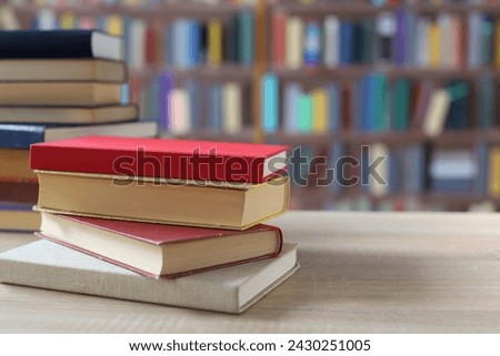 stack of books on wooden table in classroom, back to school. space for text
